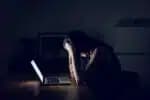 Stressed and frustrated businesswoman working till late at work
