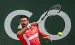 Serbia's Novak Djokovic returns a ball to Hungary's Marton Fucsovics during their match at the ATP 250 Geneva Open tennis tournament in Geneva on May 21, 2025. (Photo by FABRICE COFFRINI / AFP)