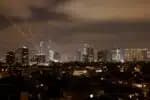 Israeli air defence systems are activated to intercept Iranian missiles over the Israeli city of Tel Aviv amid a fresh barrage of Iranian rockets on June 15, 2025. Israel and Iran traded heavy fire for a third straight day on June 15, with mounting casualties and expanding targets marking a sharp escalation in hostilities between the longtime foes. (Photo by Jalaa MAREY / AFP)