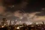 Israeli air defence systems are activated to intercept Iranian missiles over the Israeli city of Tel Aviv early on June 18, 2025. Israel and Iran exchanged fire again on June 17, the fifth day of strikes in their most intense confrontation in history, fuelling fears of a drawn-out conflict that could engulf the Middle East. (Photo by Menahem Kahana / AFP)