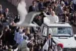 A bird flies by as Pope Leo XIV on his popemobile tours St. Peters Square at the Vatican prior to the inaugural Mass of his pontifcate, Sunday, May 18, 2025. (Photo by Jacquelyn Martin / POOL / AFP)